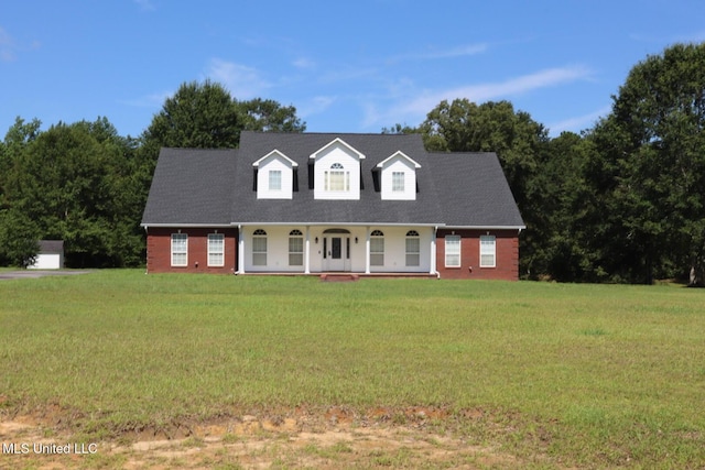 2212 Sampras Blvd, Vancleave, MS 39565 - cape cod-style house with a porch, a front lawn, and brick siding