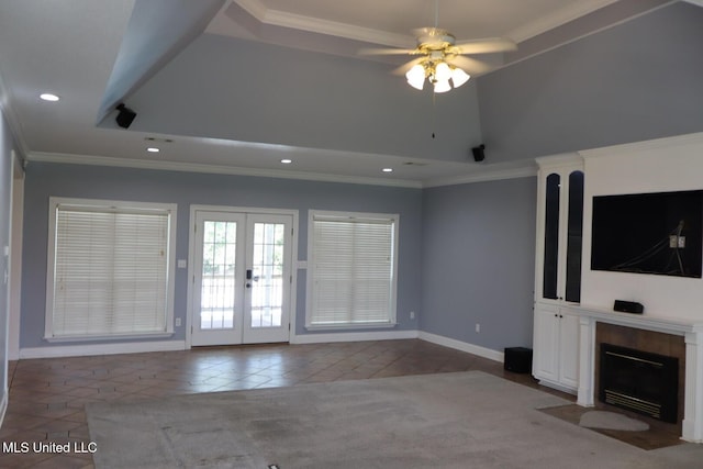 2212 Sampras Blvd, Vancleave, MS 39565 - unfurnished living room with tile patterned flooring, ceiling fan, french doors, ornamental molding, and a fireplace with flush hearth