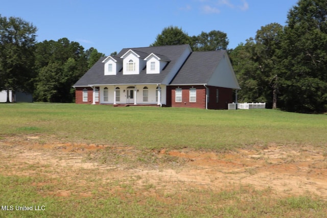 2212 Sampras Blvd, Vancleave, MS 39565 - cape cod home with a porch, a front yard, and brick siding