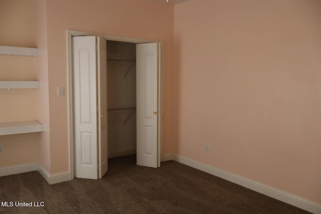2212 Sampras Blvd, Vancleave, MS 39565 - unfurnished bedroom featuring dark colored carpet and a closet