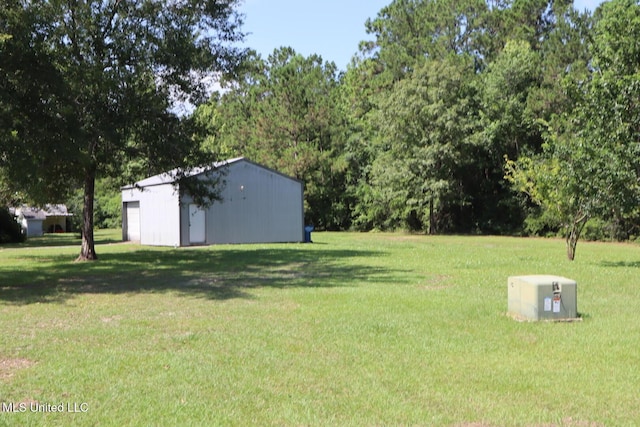 2212 Sampras Blvd, Vancleave, MS 39565 - view of green lawn with an outbuilding and a garage