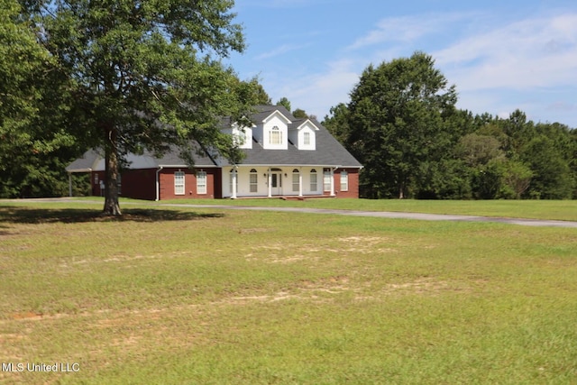 2212 Sampras Blvd, Vancleave, MS 39565 - cape cod house featuring covered porch, a front lawn, and brick siding
