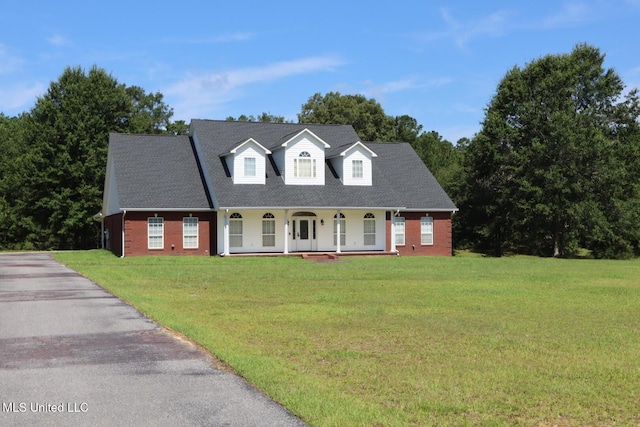 2212 Sampras Blvd, Vancleave, MS 39565 - new england style home with a porch, brick siding, a front yard, and driveway