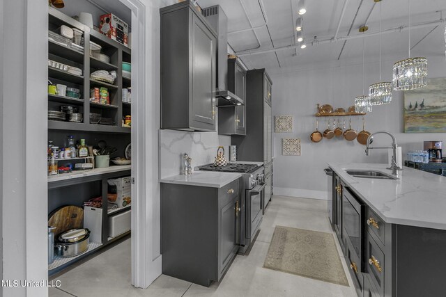 kitchen with gray cabinetry, light stone countertops, sink, stainless steel appliances, and pendant lighting