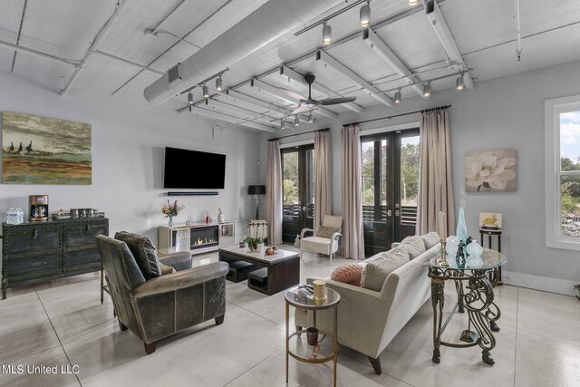 living room featuring french doors and ceiling fan