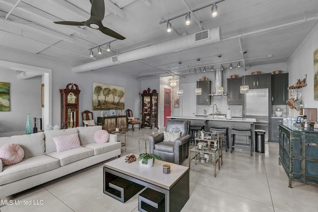 living room featuring sink and ceiling fan