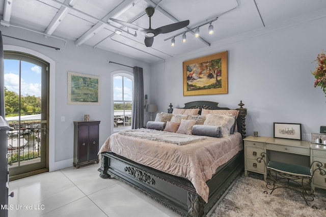 bedroom featuring ceiling fan, multiple windows, and access to exterior