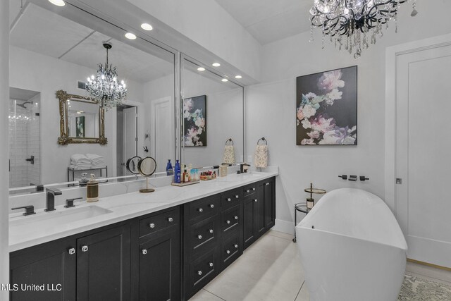 bathroom with vanity, tile patterned floors, an inviting chandelier, and shower with separate bathtub