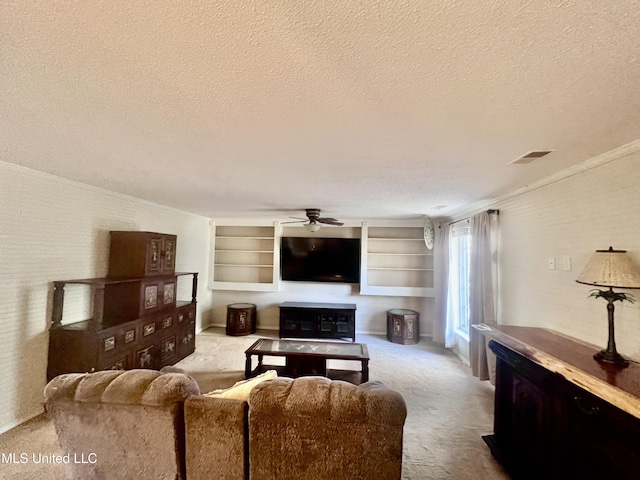 116 E Tate St, Senatobia, MS 38668 - living area with a textured ceiling, visible vents, ceiling fan, and carpet