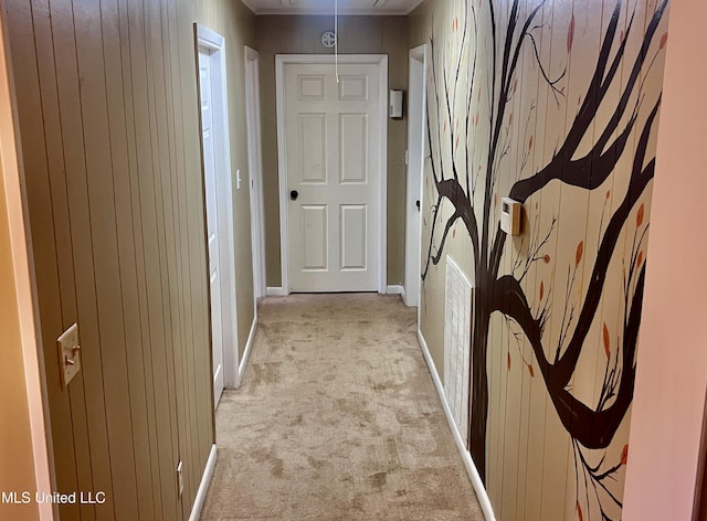 116 E Tate St, Senatobia, MS 38668 - hall featuring wood walls, baseboards, attic access, radiator, and light colored carpet