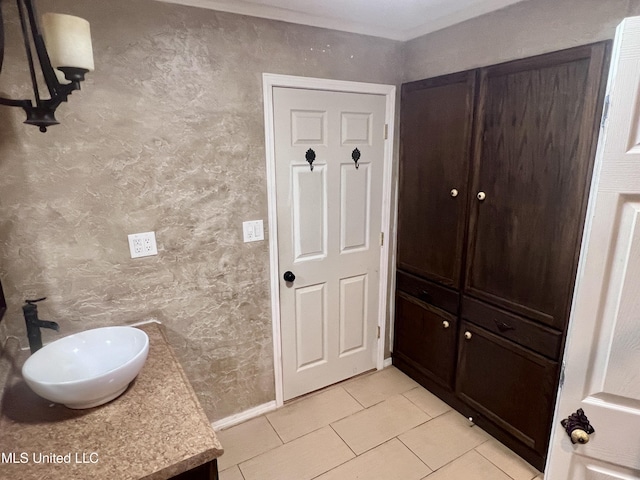116 E Tate St, Senatobia, MS 38668 - bathroom with vanity, baseboards, tile patterned flooring, and a textured wall
