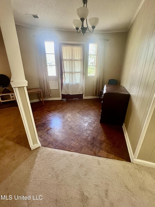 116 E Tate St, Senatobia, MS 38668 - interior space with baseboards, a textured ceiling, an inviting chandelier, and crown molding