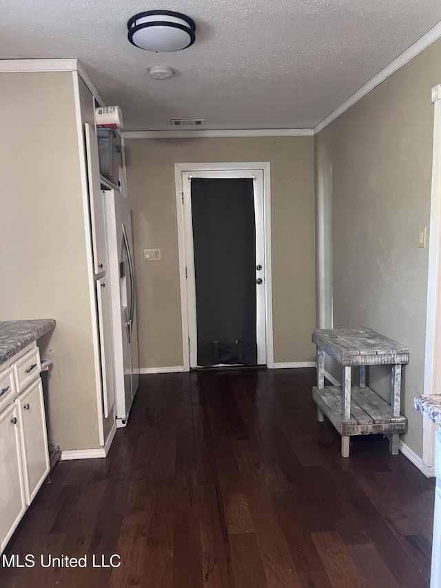 116 E Tate St, Senatobia, MS 38668 - hall with ornamental molding, dark wood-type flooring, and a textured ceiling