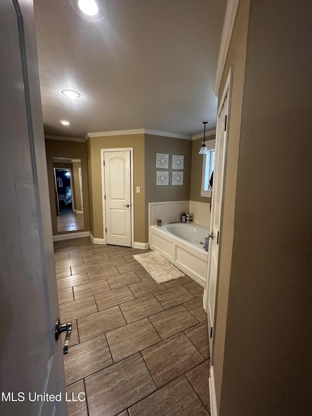 17931 Rayford Shumock Rd, Moss Point, MS 39562 - bathroom featuring a garden tub, crown molding, and wood finish floors