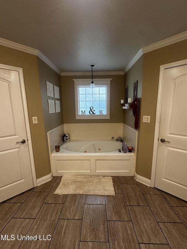 17931 Rayford Shumock Rd, Moss Point, MS 39562 - bathroom with a tub with jets, wood finish floors, and ornamental molding