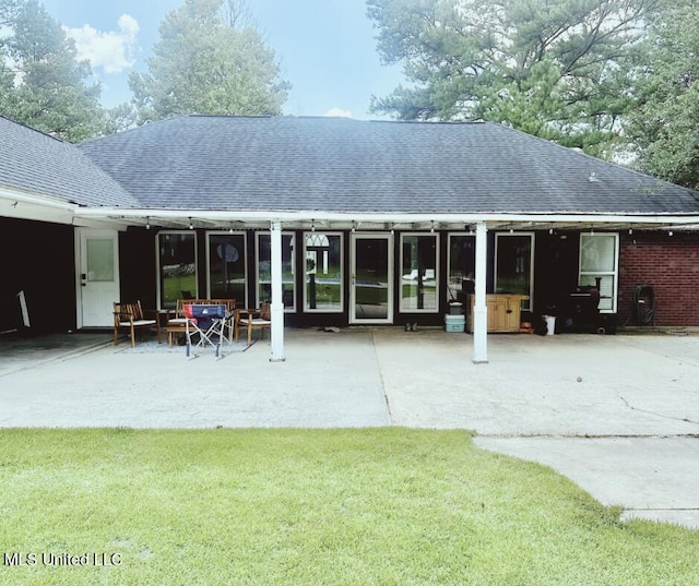 17931 Rayford Shumock Rd, Moss Point, MS 39562 - back of property featuring a shingled roof, a yard, and a patio area