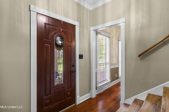 foyer entrance featuring stairway, ornamental molding, baseboards, and wood finished floors