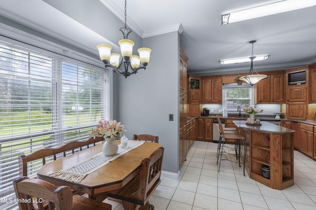 dining room featuring ornamental molding, light tile patterned floors, a chandelier, and baseboards