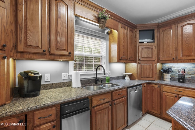 kitchen featuring stainless steel dishwasher, a sink, and brown cabinetry
