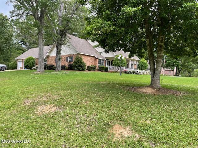 view of side of property featuring a yard and a garage
