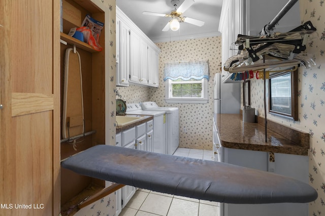 clothes washing area featuring cabinet space, wallpapered walls, light tile patterned floors, ceiling fan, and crown molding