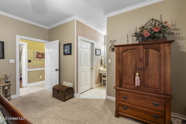 bedroom featuring light tile patterned floors, light carpet, ornamental molding, baseboards, and connected bathroom