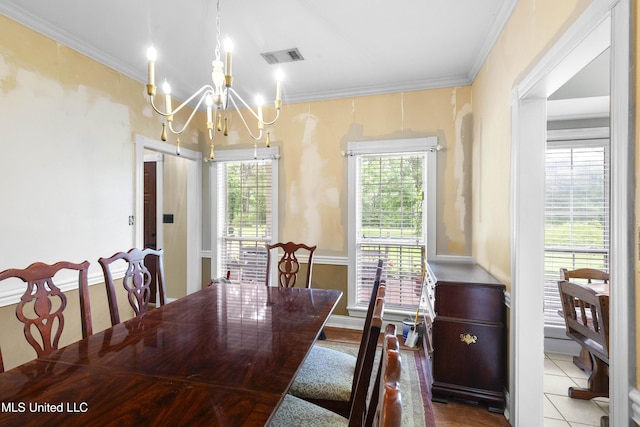 tiled dining space with a chandelier and crown molding