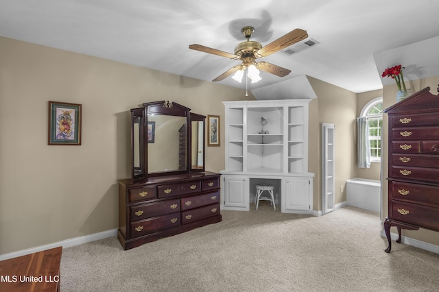 bedroom featuring baseboards, light colored carpet, an office area, and a ceiling fan