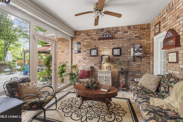 living room with brick wall and ceiling fan