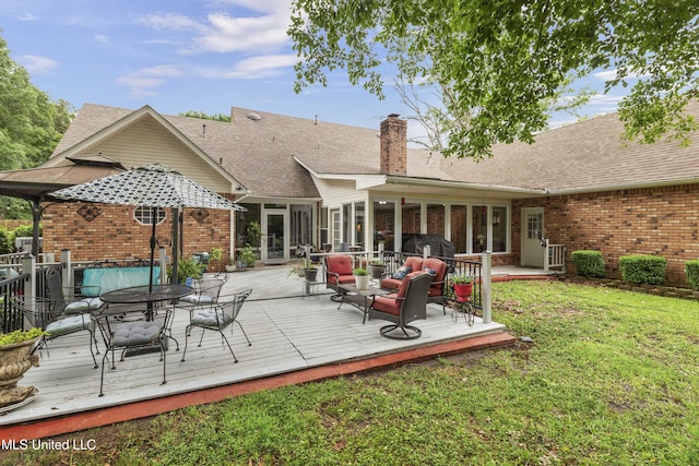 rear view of house featuring brick siding, a chimney, a lawn, and outdoor dining area