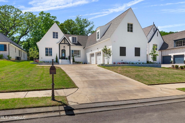 323 Penrose Pl, Madison, MS 39110 - view of front facade with driveway, a front lawn, central air condition unit, an attached garage, and stucco siding