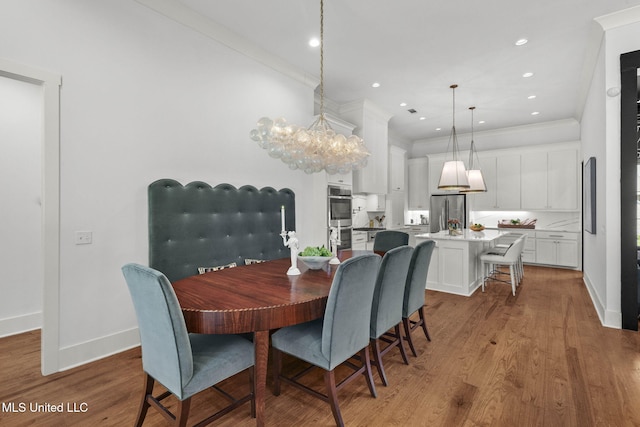 323 Penrose Pl, Madison, MS 39110 - dining area with a chandelier, crown molding, baseboards, wood finished floors, and recessed lighting
