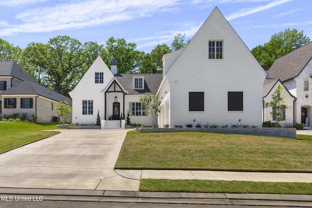323 Penrose Pl, Madison, MS 39110 - view of front of house with a chimney, a front yard, and concrete driveway