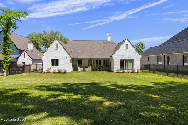 323 Penrose Pl, Madison, MS 39110 - back of house featuring brick siding, a patio, and a chimney