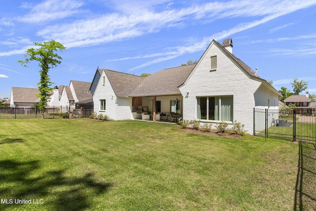 323 Penrose Pl, Madison, MS 39110 - rear view of house featuring a chimney, a patio area, outdoor lounge area, and brick siding