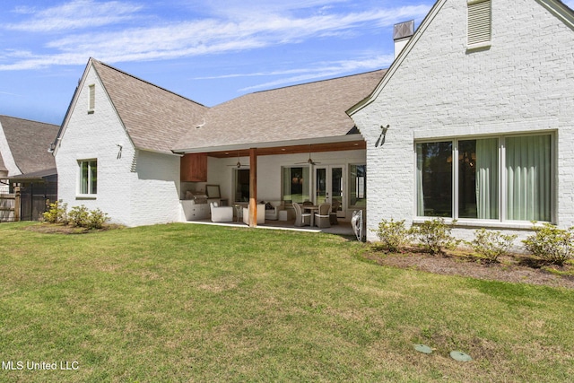 323 Penrose Pl, Madison, MS 39110 - back of house with ceiling fan, brick siding, an outdoor living space, a lawn, and a patio