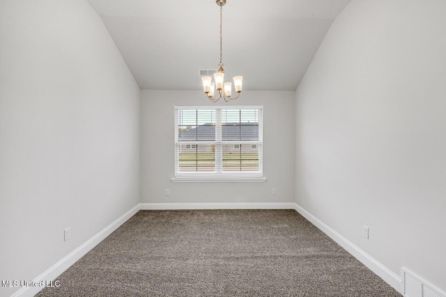 carpeted empty room featuring lofted ceiling and an inviting chandelier