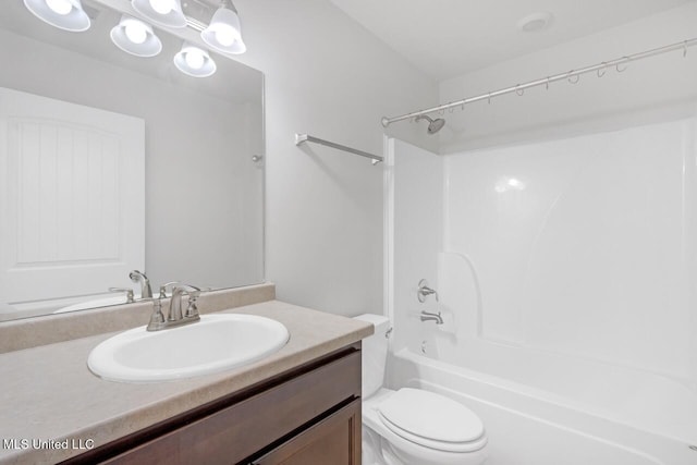 full bathroom featuring toilet, vanity, and shower / washtub combination