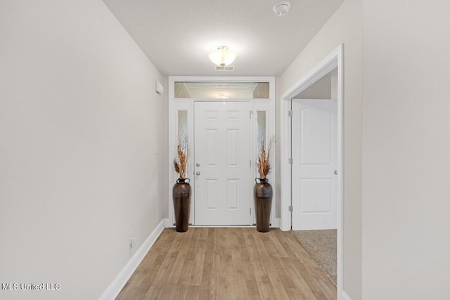 entryway with light hardwood / wood-style floors