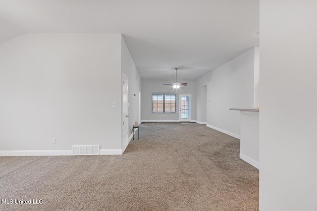 unfurnished living room featuring carpet flooring, ceiling fan, and vaulted ceiling