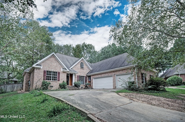 view of front of property with a front yard and a garage