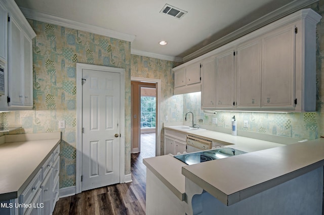 kitchen with kitchen peninsula, white cabinets, white dishwasher, dark wood-type flooring, and sink