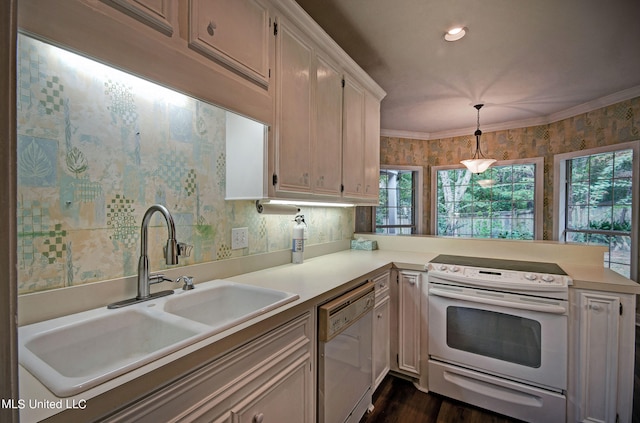 kitchen featuring white cabinetry, decorative light fixtures, sink, and white appliances