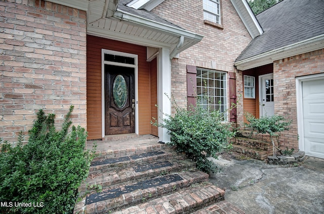 view of exterior entry with a garage