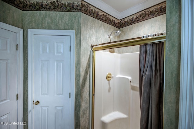 bathroom with ornamental molding and walk in shower