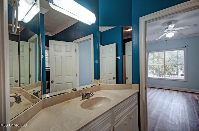 bathroom with vanity, crown molding, wood-type flooring, and ceiling fan