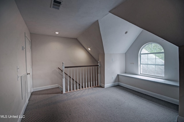 bonus room featuring vaulted ceiling and carpet floors