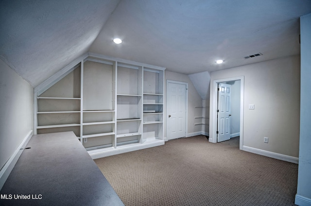 additional living space with lofted ceiling, carpet floors, and built in shelves