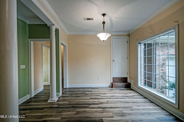 unfurnished dining area featuring decorative columns, hardwood / wood-style flooring, and plenty of natural light