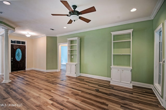 foyer featuring ornamental molding, dark wood-type flooring, ornate columns, and ceiling fan